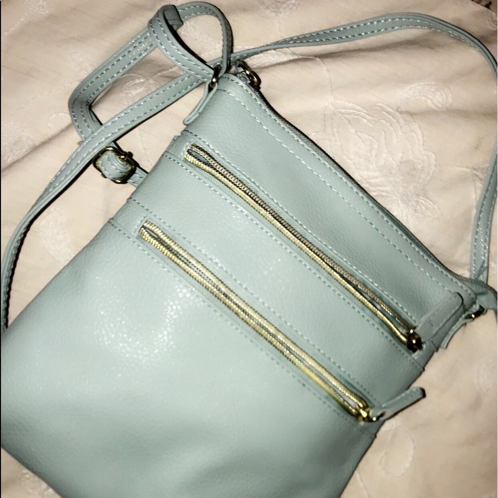 teal purse with gold zippers